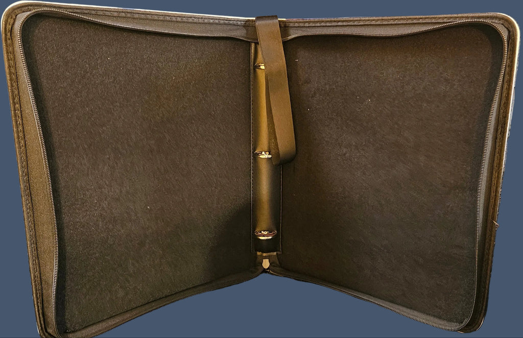 Brown leather case with gold clasp on a gray textured surface