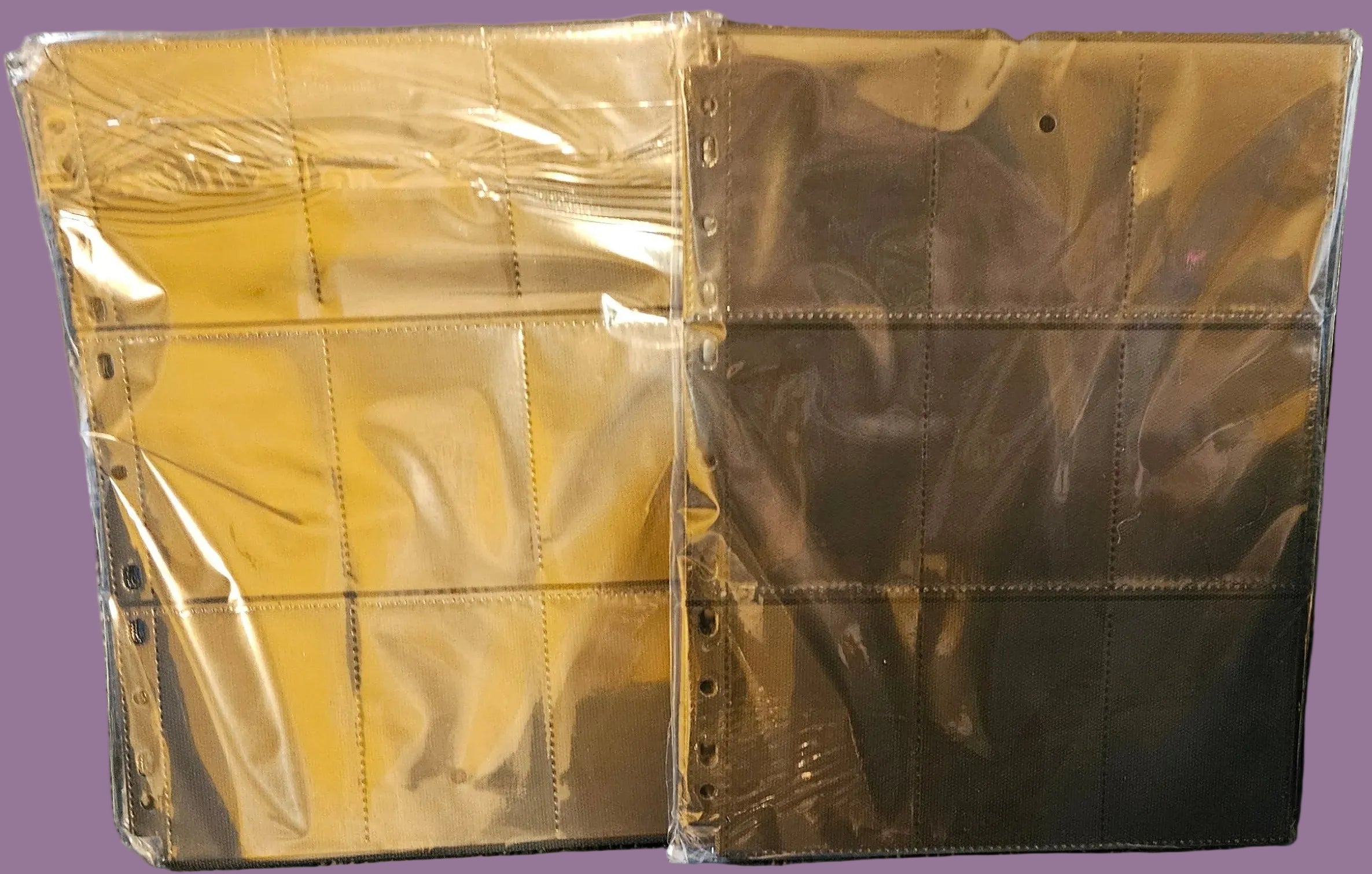 Two gold-colored metal boxes wrapped in clear plastic on a blue background